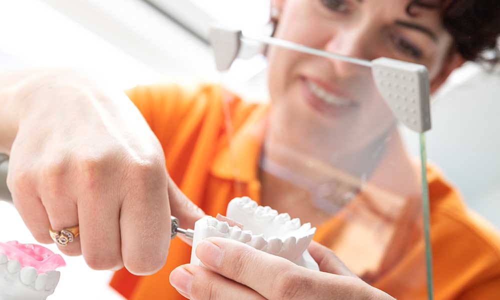 MTA schleift mit einem kleinen Gerät den Zahnabdruck für die Anfertigung der Zahnspange zurecht